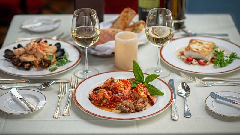 Three plated entrees focused on shrimp and clams.